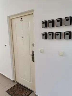 a white door with the number four on it at Airport Apartments in Belgrade