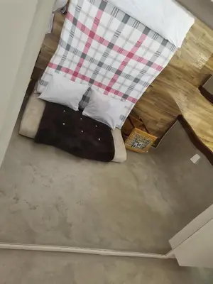 a bed in the middle of a room at Airport Apartments in Belgrade