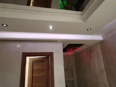 a bathroom with a ceiling with lights and a mirror at Airport Apartments in Belgrade