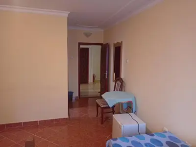 a room with a bed and a table and chairs at Kuca Veljovica in Belgrade