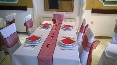 a white table with red napkins on top of it at Kuca Veljovica in Belgrade