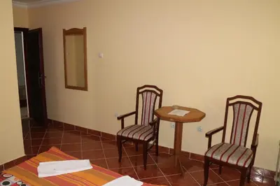 a room with a table and two chairs and a table at Kuca Veljovica in Belgrade