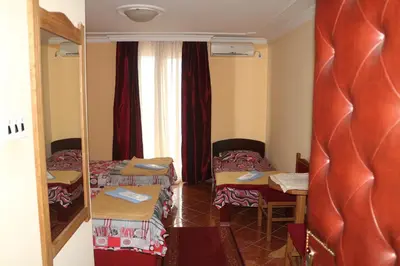 a small room with two beds and a table at Kuca Veljovica in Belgrade