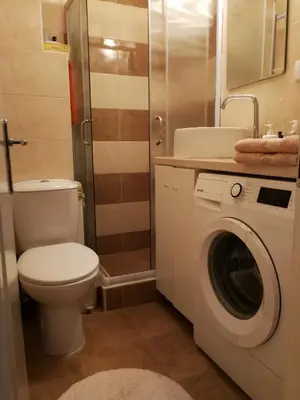 a bathroom with a toilet and a washing machine at Imperia Apartments in Belgrade