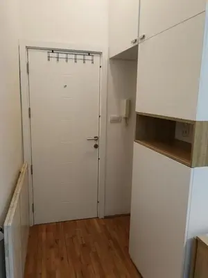 a white door in a room with a wooden floor at Imperia Apartments in Belgrade