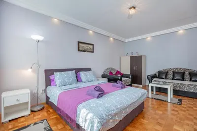 a bedroom with a bed and a couch at Apartment Gloria in Belgrade