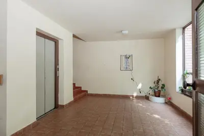 an empty hallway with a door and a tile floor at Apartment Gloria in Belgrade
