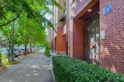 a sidewalk next to a red brick building at Apartment Gloria in Belgrade