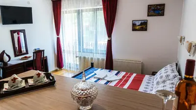 a small room with a bed and a table with a table at Apartmani 