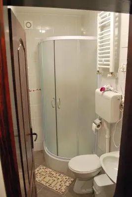 a bathroom with a shower and a toilet and a sink at Apartmani 