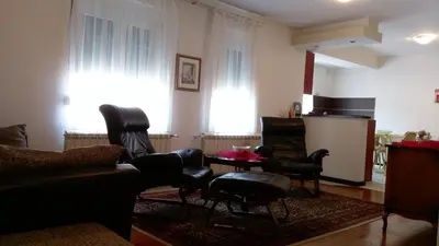 a living room with leather chairs and a table at Apartment Krsmanovic in Arandjelovac