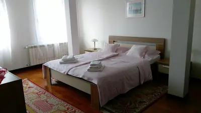 a bedroom with a bed with two towels on it at Apartment Krsmanovic in Arandjelovac