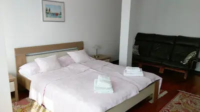 a bedroom with a large bed with two towels on it at Apartment Krsmanovic in Arandjelovac