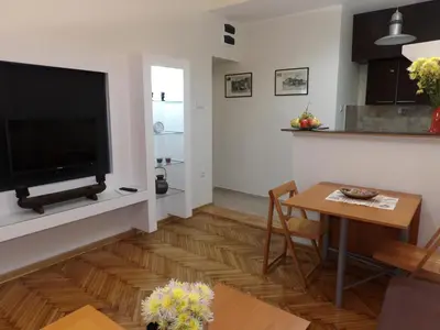 a living room with a television and a table at M&M Downtown Apartment in Belgrade