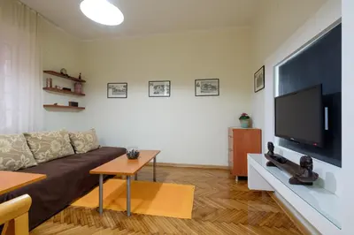 a living room with a couch and a flat screen tv at M&M Downtown Apartment in Belgrade