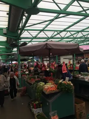 a group of people walking around a market with produce at M&M Downtown Apartment in Belgrade