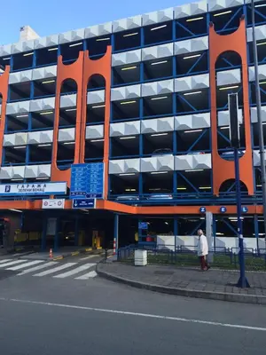 a large building with a large orange sign in front of it at M&M Downtown Apartment in Belgrade