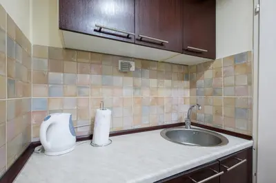 a small kitchen with a sink and a toilet at M&M Downtown Apartment in Belgrade