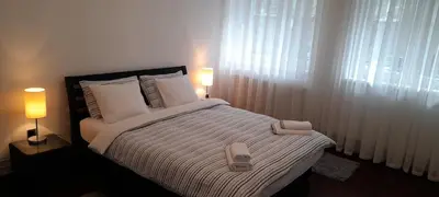 a bedroom with a bed with two towels on it at Apartment Dok in Belgrade