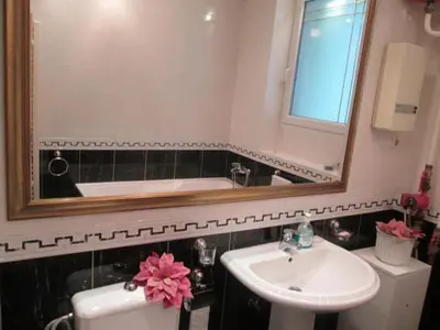 a bathroom with a sink and a mirror and a tub at Apartment Dok in Belgrade