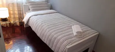 a small bed in a corner of a room at Apartment Dok in Belgrade