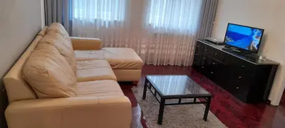 a living room with a couch and a flat screen tv at Apartment Dok in Belgrade