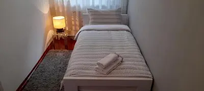 a bed with a phone sitting on top of it at Apartment Dok in Belgrade