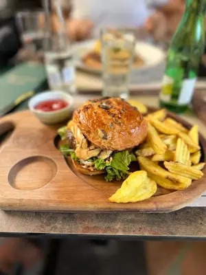 a plate of food with a sandwich and french fries at Pleasure Lux1 Apartment in Belgrade