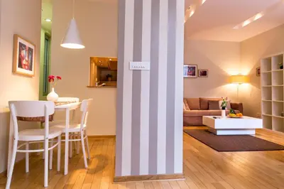 a living room with a table and chairs and a couch at Apartment Centro in Belgrade