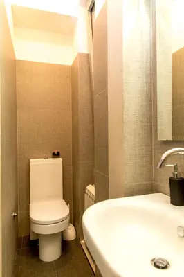 a bathroom with a white toilet and a sink at Apartment Centro in Belgrade