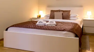 a bedroom with a large bed with towels on it at Apartment Centro in Belgrade