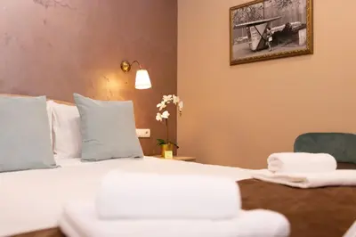 a hotel room with a bed and a chair at Skadarlija Suites in Belgrade