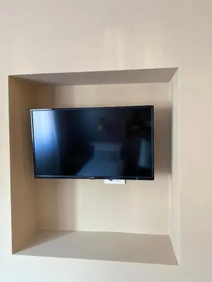 a flat screen tv hanging on a wall at Skadarlija Suites in Belgrade