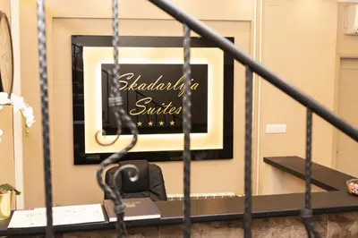 a black and white picture on a wall with a chair at Skadarlija Suites in Belgrade