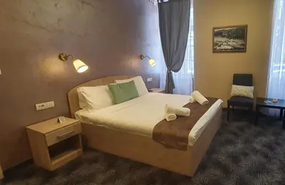 a bedroom with a bed with two towels on it at Skadarlija Suites in Belgrade