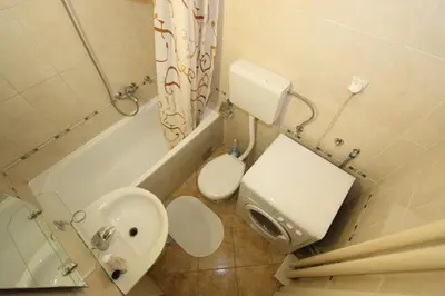 a small bathroom with a toilet and a sink at New Belgrade Apartment IN in Belgrade