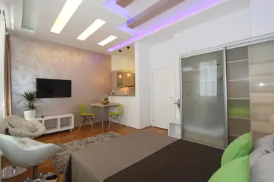 a living room with a bed and a tv and a room at New Belgrade Apartment IN in Belgrade