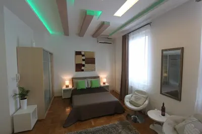 a bedroom with a bed and a green ceiling at New Belgrade Apartment IN in Belgrade