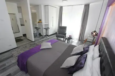 a bedroom with a large bed with pillows at New Belgrade Apartment ARENA in Belgrade