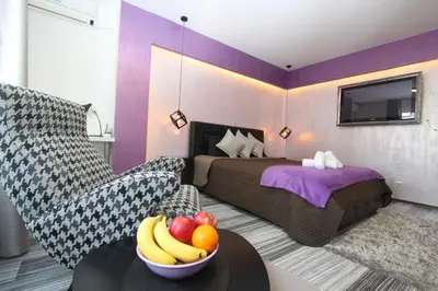 a bedroom with a bed and a bowl of fruit on a table at New Belgrade Apartment ARENA in Belgrade