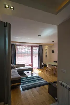 a living room with a couch and a table at Apartment Savamala Art in Belgrade