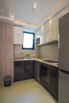 a kitchen with stainless steel appliances and a window at Apartment Savamala Art in Belgrade