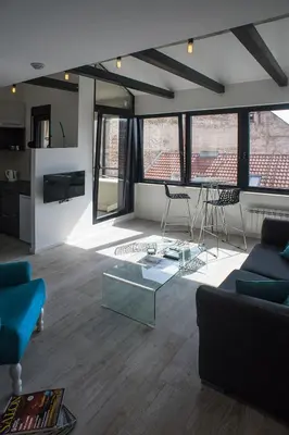 a living room with a couch and a table at Apartment Savamala Art in Belgrade