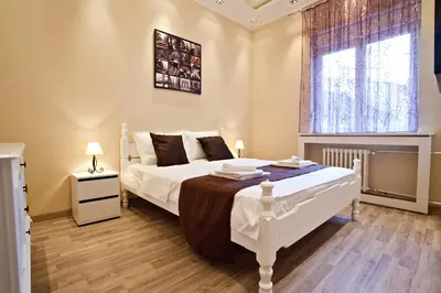 a bedroom with a white bed and a window at Feel Belgrade Bohemian Apartment in Belgrade