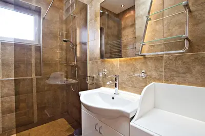a bathroom with a sink and a shower and a toilet at Feel Belgrade Bohemian Apartment in Belgrade