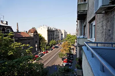 a view of a city street from an apartment balcony at Feel Belgrade Bohemian Apartment in Belgrade