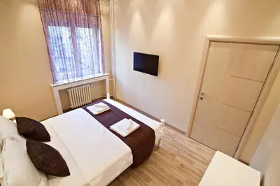a small bedroom with a bed and a window at Feel Belgrade Bohemian Apartment in Belgrade