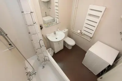 a bathroom with a sink and a toilet and a mirror at New Belgrade apartment Neven, parking 5 evra dan in Belgrade