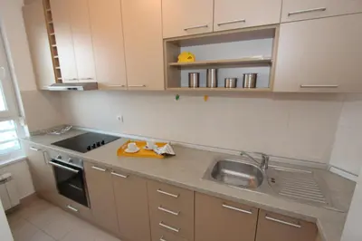 a small kitchen with a sink and a stove at New Belgrade apartment Neven, parking 5 evra dan in Belgrade