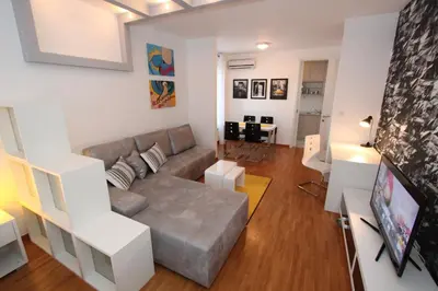 a living room with a couch and a tv at New Belgrade apartment Neven, parking 5 evra dan in Belgrade